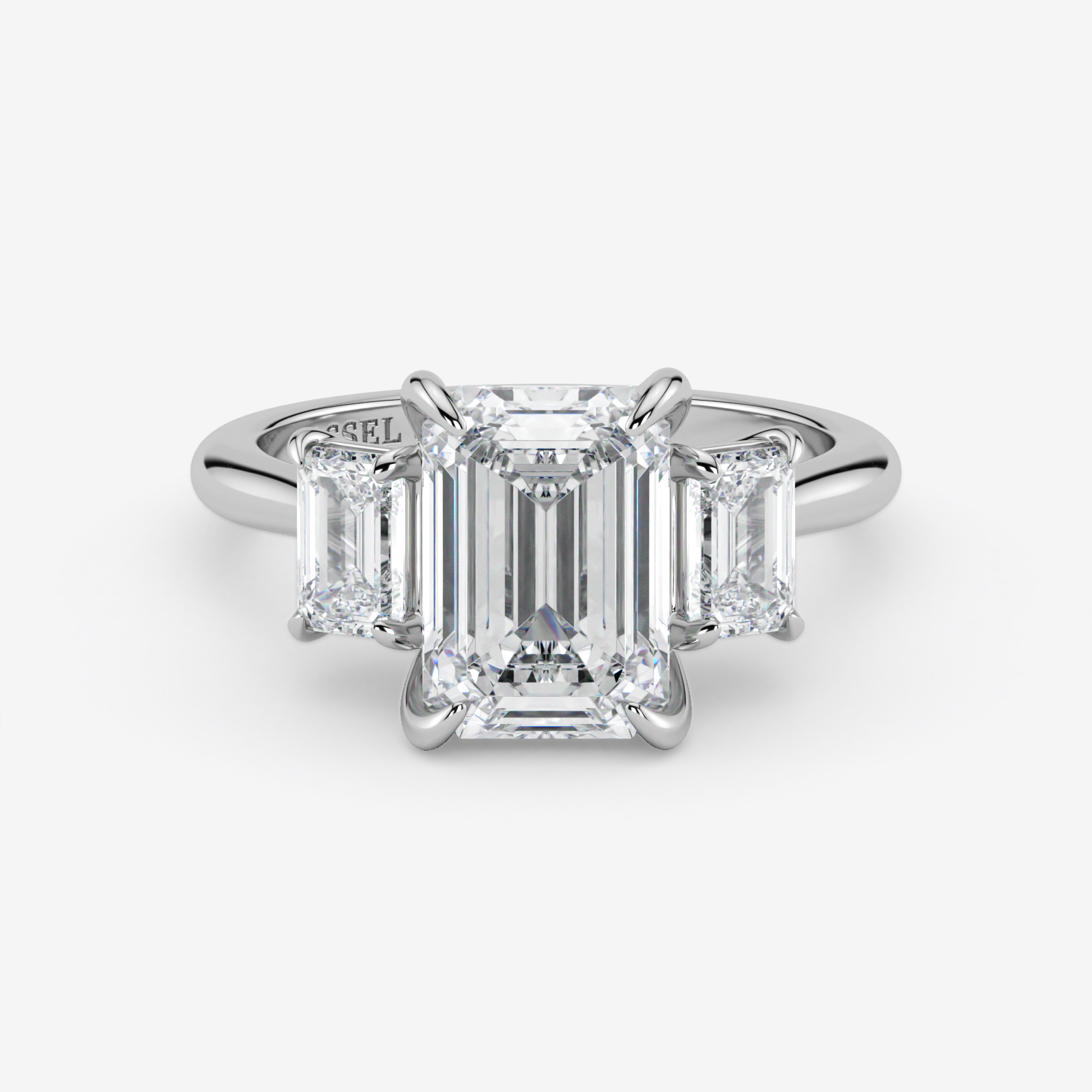 Diamond ring with emerald-cut stones on a white background