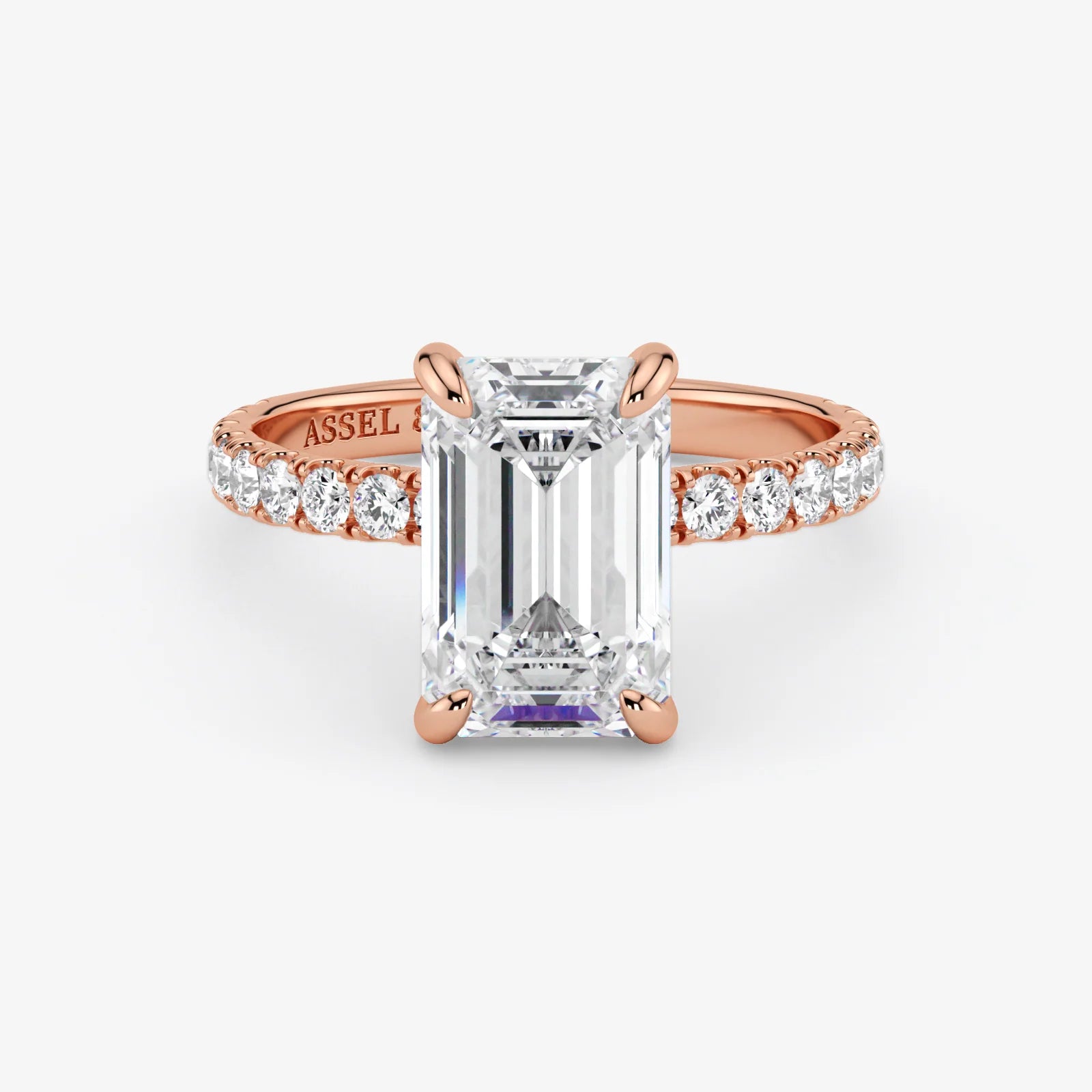 Rose gold ring with a large diamond and smaller diamonds on the band against a white background