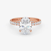 Rose gold ring with a large diamond and smaller diamonds on the band against a white background