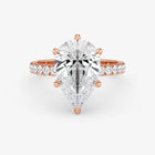 Rose gold ring with a large diamond and smaller diamonds on the band against a white background