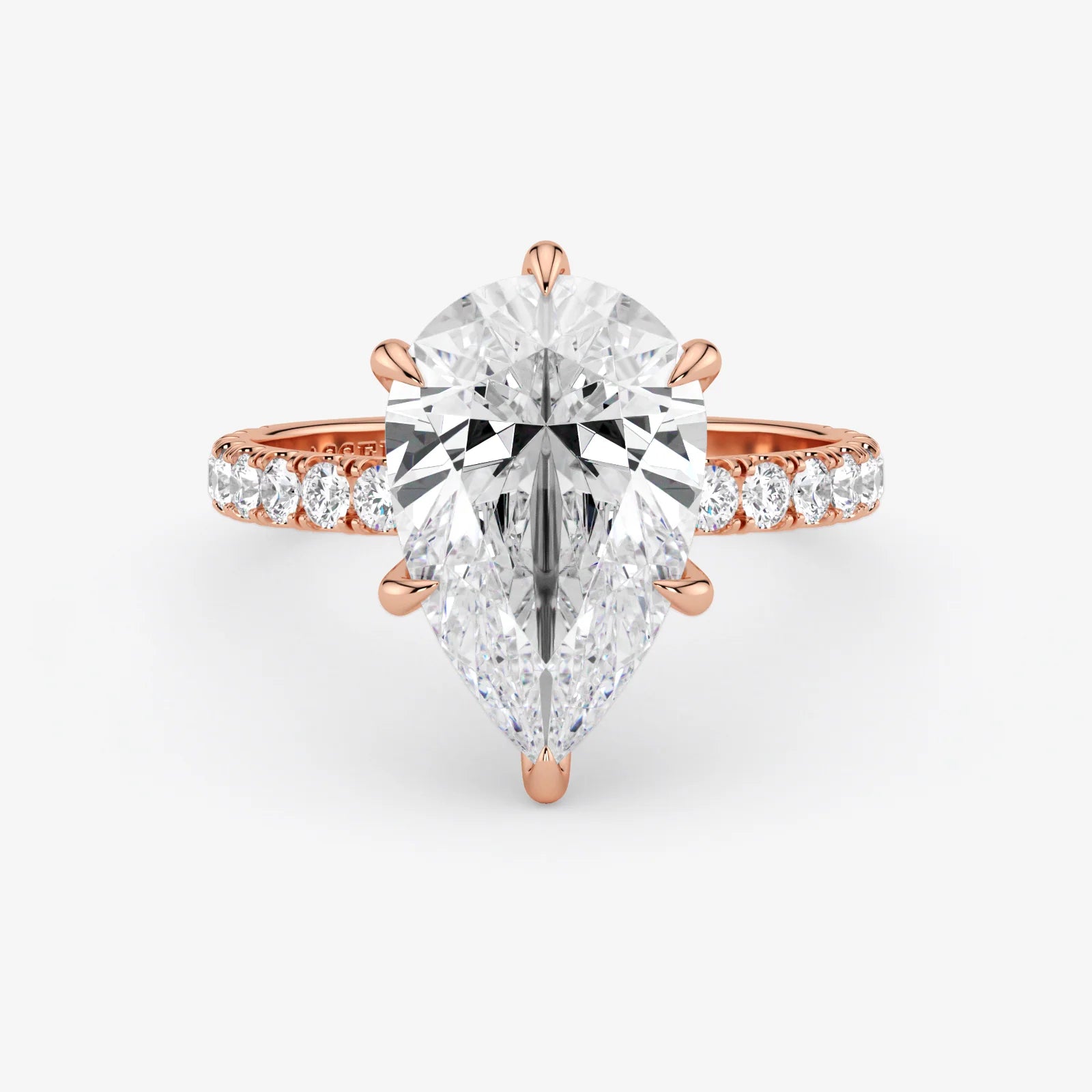 Rose gold ring with a large diamond and smaller diamonds on the band against a white background