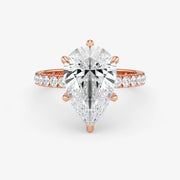 Rose gold ring with a large diamond and smaller diamonds on the band against a white background