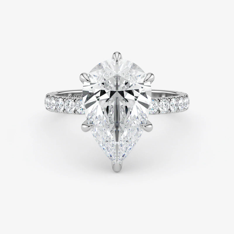 Diamond ring with a pear-shaped center stone on a white background