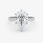 Diamond ring with a pear-shaped center stone on a white background