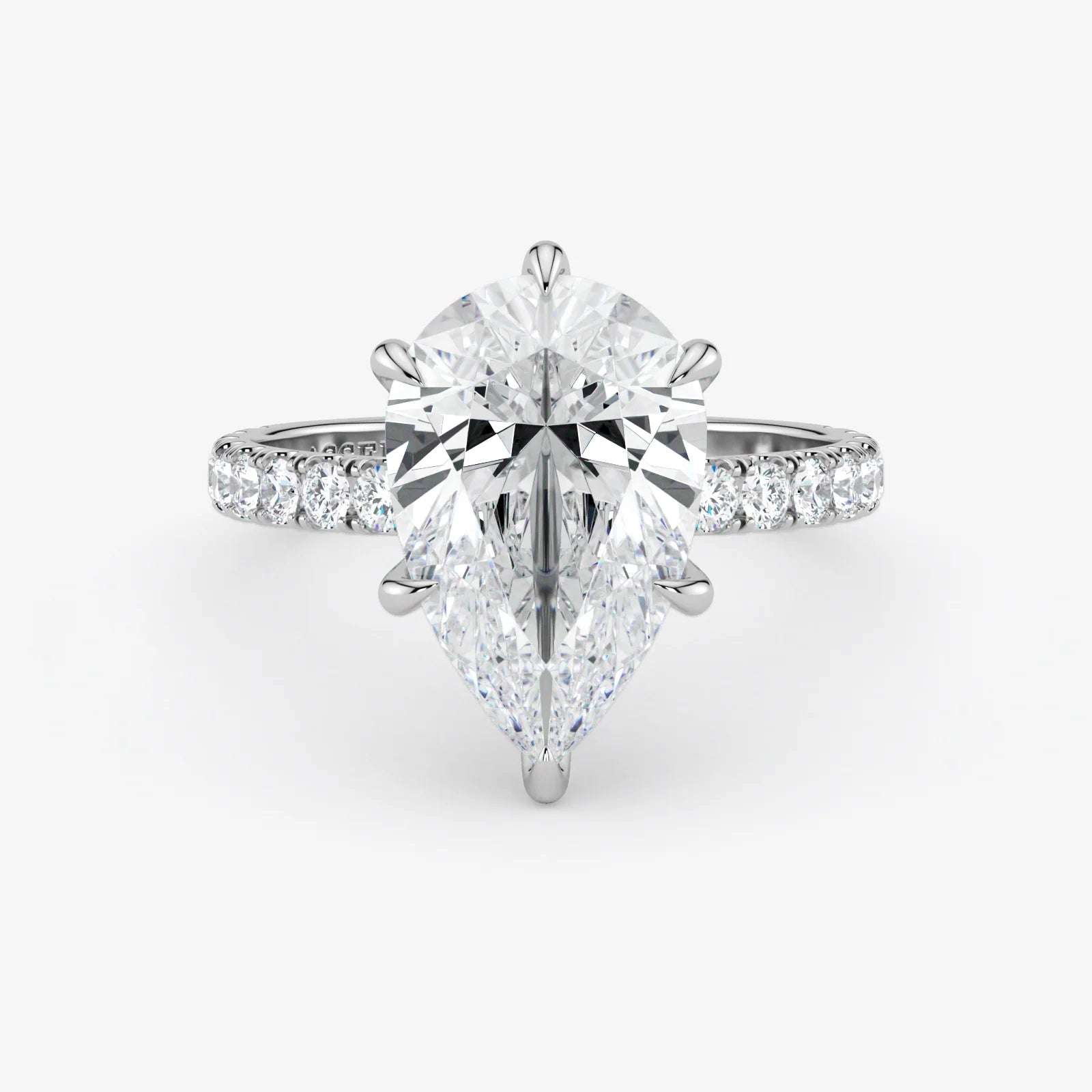 Diamond ring with a pear-shaped center stone on a white background