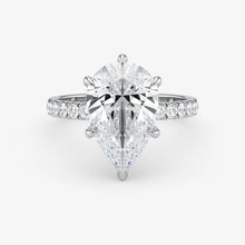 Diamond ring with a pear-shaped center stone on a white background