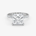 Diamond ring with a princess-cut diamond on a white background