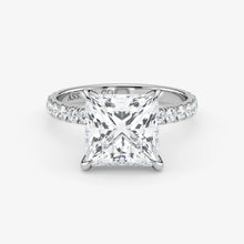 Diamond ring with a princess-cut diamond on a white background