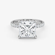 Diamond ring with a princess-cut diamond on a white background