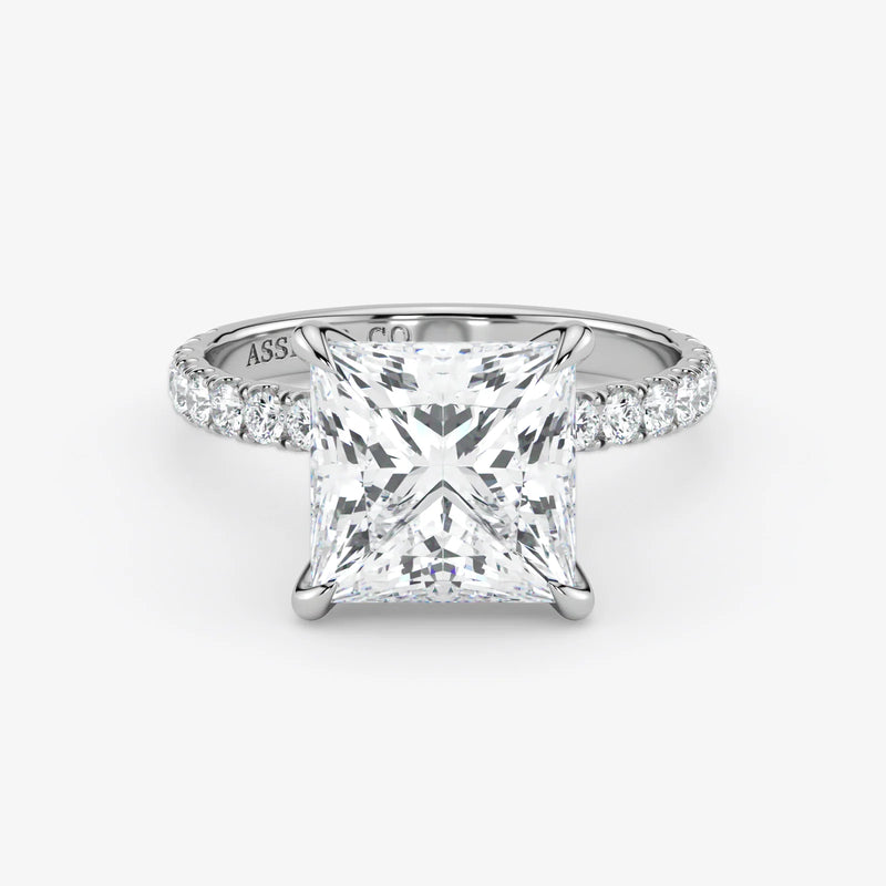 Diamond ring with a princess-cut diamond on a white background