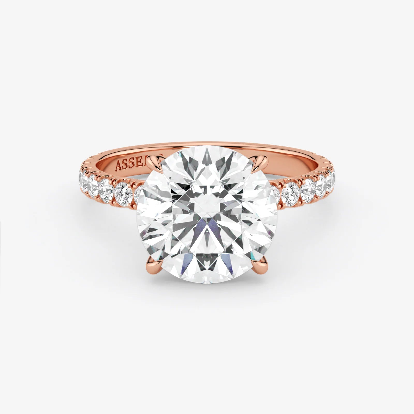 Rose gold ring with a large diamond and smaller diamonds on the band against a white background