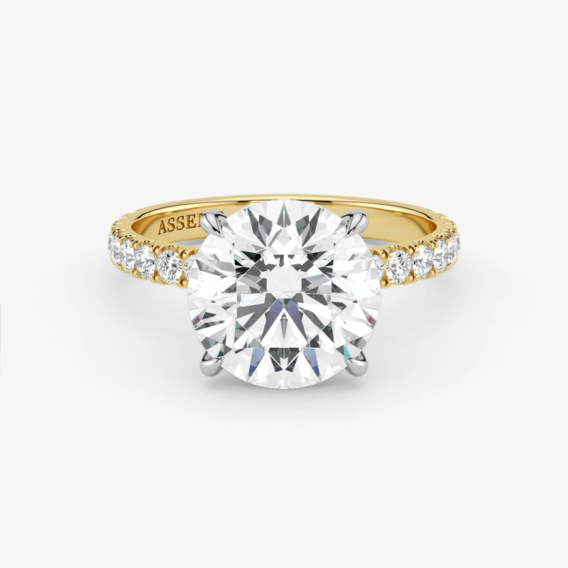 Gold ring with a large diamond on a white background