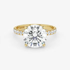 Gold ring with a large diamond on a white background