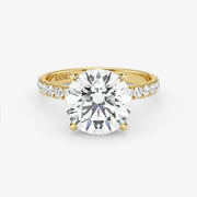 Gold ring with a large diamond on a white background