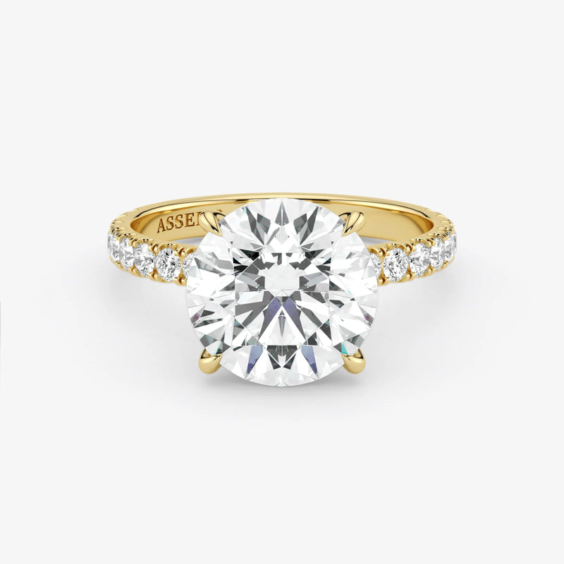 Gold ring with a large diamond on a white background