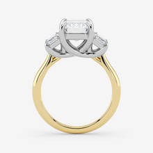 Two-tone gold ring with diamond accents on a white background