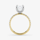 Two-tone diamond ring with a heart-shaped center stone on a white background