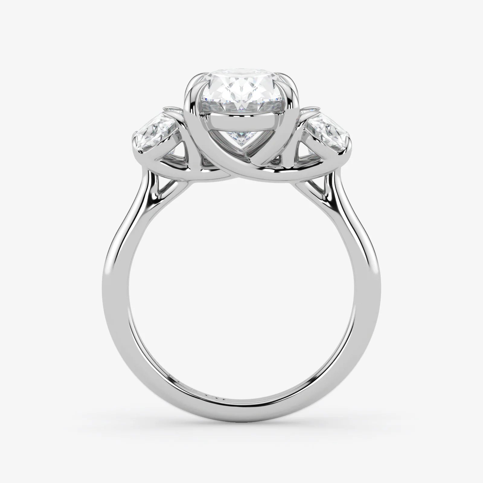 Silver ring with a central diamond and two smaller diamonds on a white background