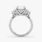 Silver ring with a central diamond and two smaller diamonds on a white background
