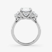 Silver ring with a central diamond and two smaller diamonds on a white background