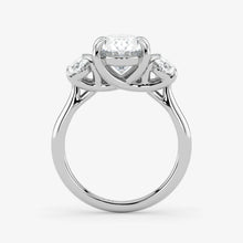 Silver ring with a central diamond and two smaller diamonds on a white background