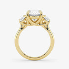 Gold ring with three diamond stones on a white background