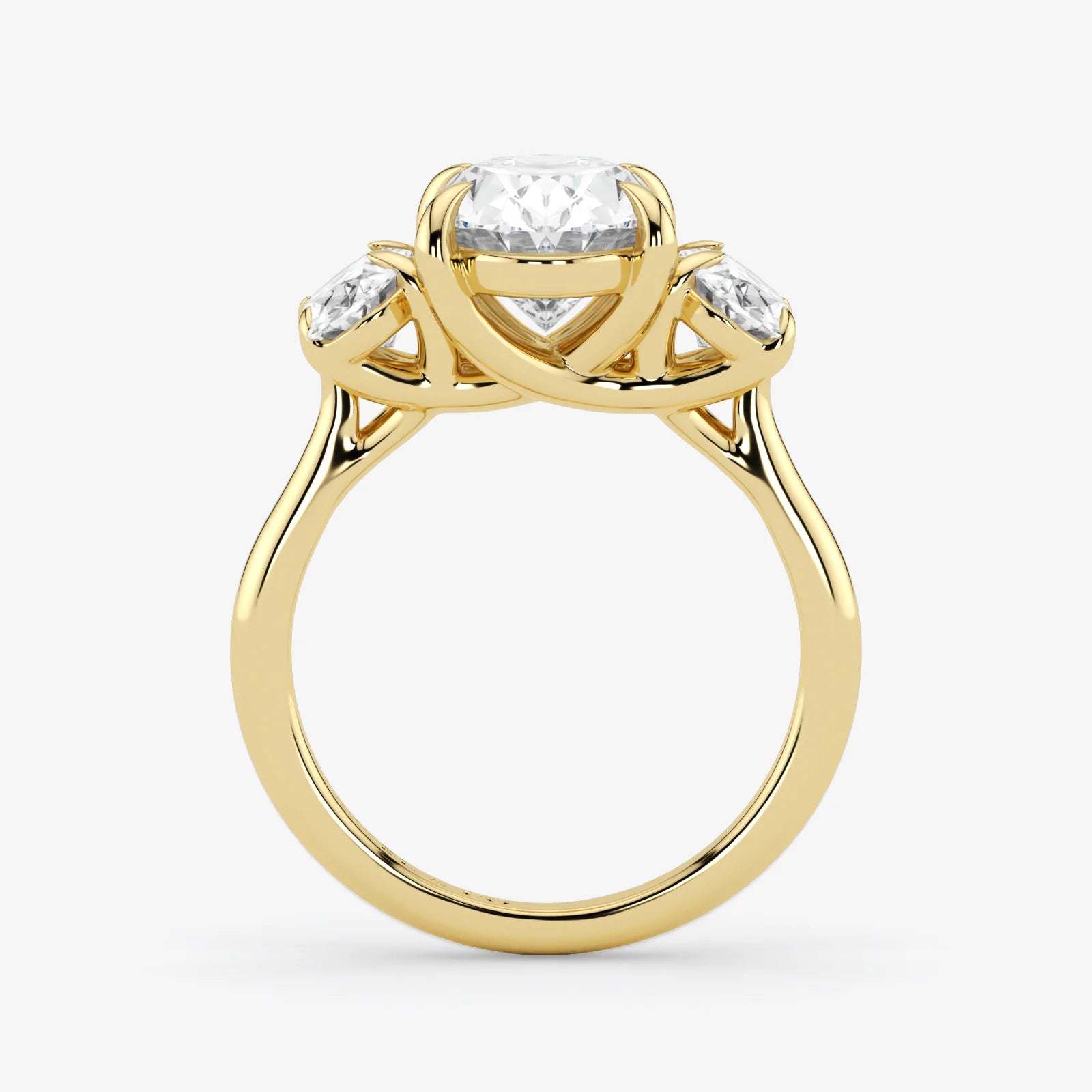 Gold ring with three diamond stones on a white background
