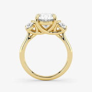Gold ring with three diamond stones on a white background
