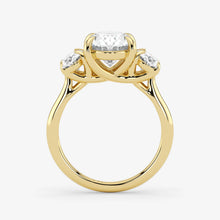 Gold ring with three diamond stones on a white background