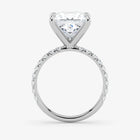 Diamond ring with a heart-shaped center stone on a white background
