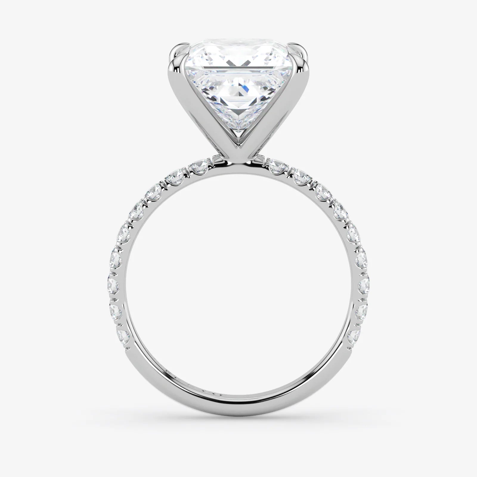 Diamond ring with a heart-shaped center stone on a white background