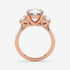 Rose gold ring with a central diamond and smaller diamonds on a white background