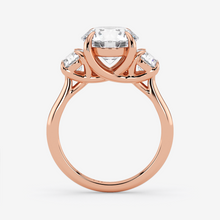 Rose gold ring with a central diamond and smaller diamonds on a white background