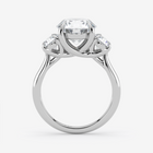 Silver ring with a central diamond and two smaller diamonds on a white background