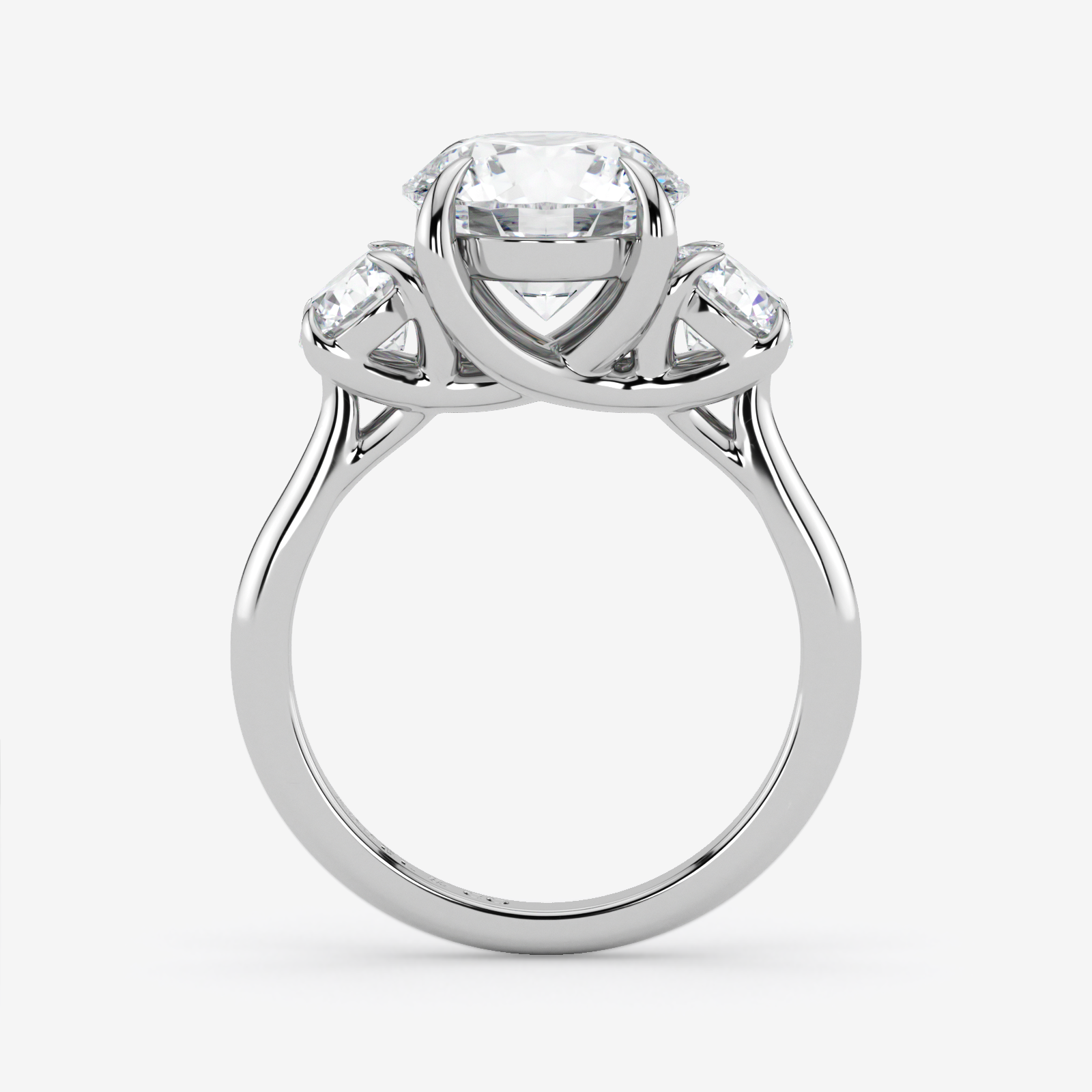 Silver ring with a central diamond and two smaller diamonds on a white background