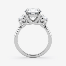 Silver ring with a central diamond and two smaller diamonds on a white background