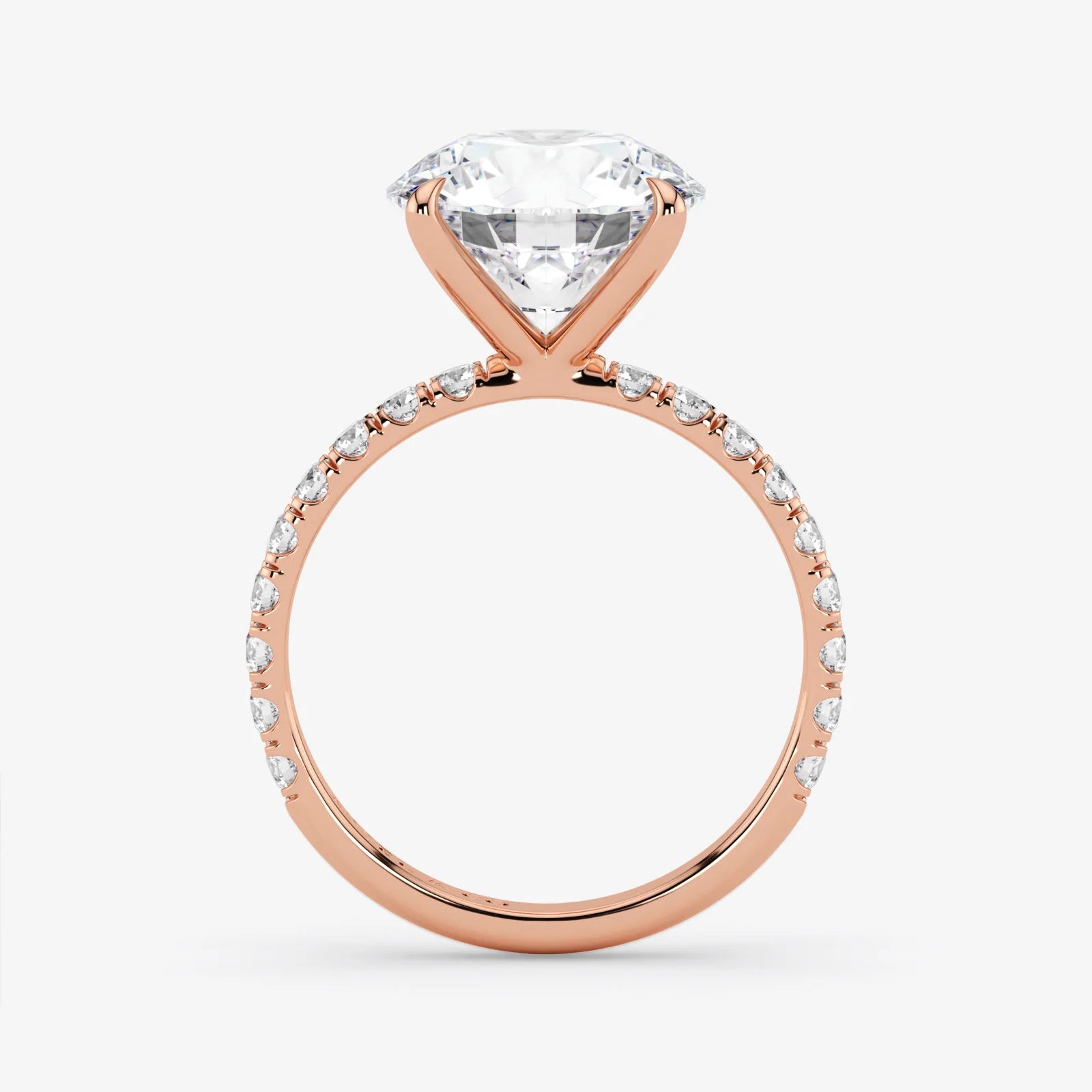 Rose gold ring with a large diamond and smaller diamonds on the band against a white background