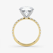 Gold ring with a large diamond and smaller diamonds on the band against a white background