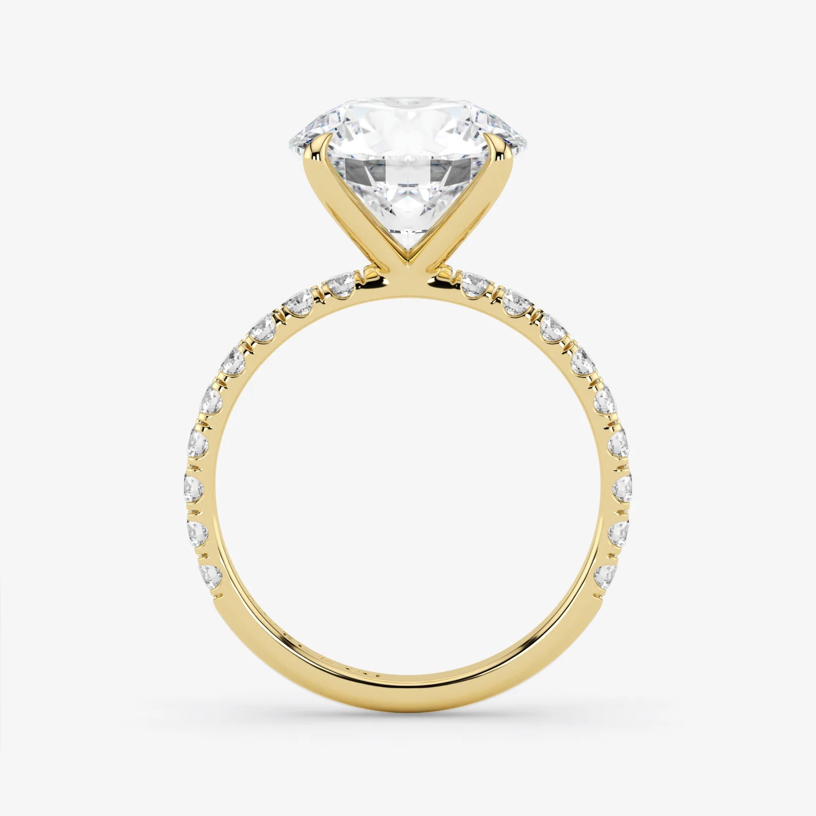 Gold ring with a large diamond and smaller diamonds on the band against a white background