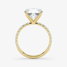 Gold ring with a large diamond and smaller diamonds on the band against a white background
