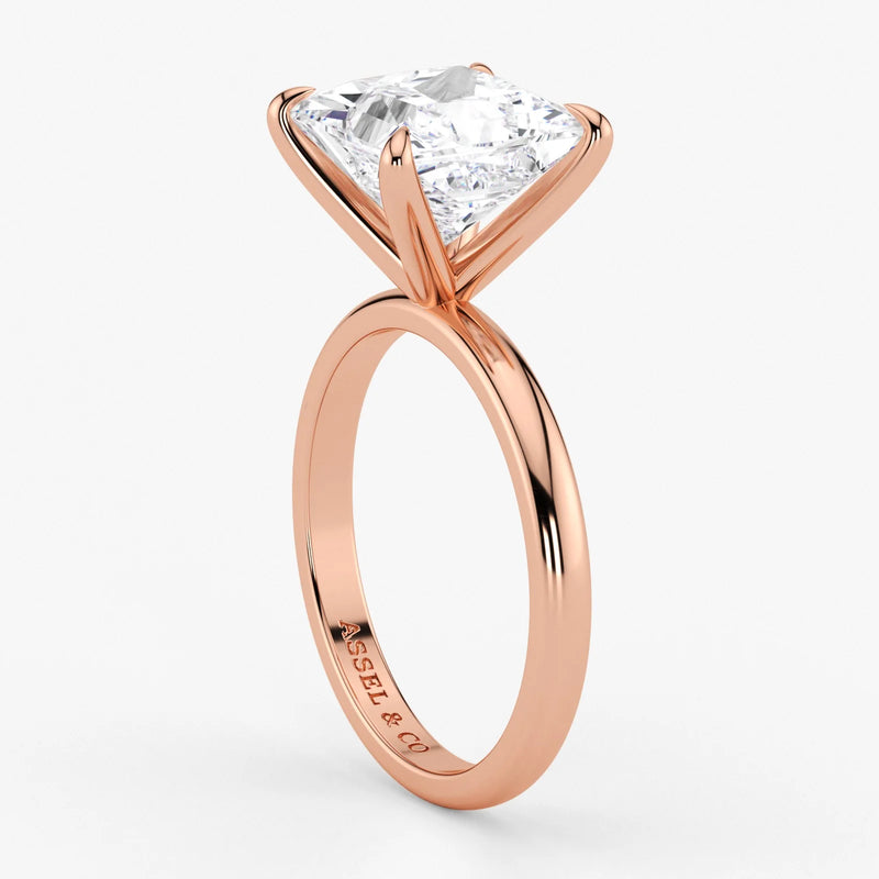 Close-up of princess cut lab diamond set in warm rose gold band