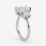 Diamond ring with two rectangular diamonds on a white background