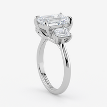 Diamond ring with two rectangular diamonds on a white background