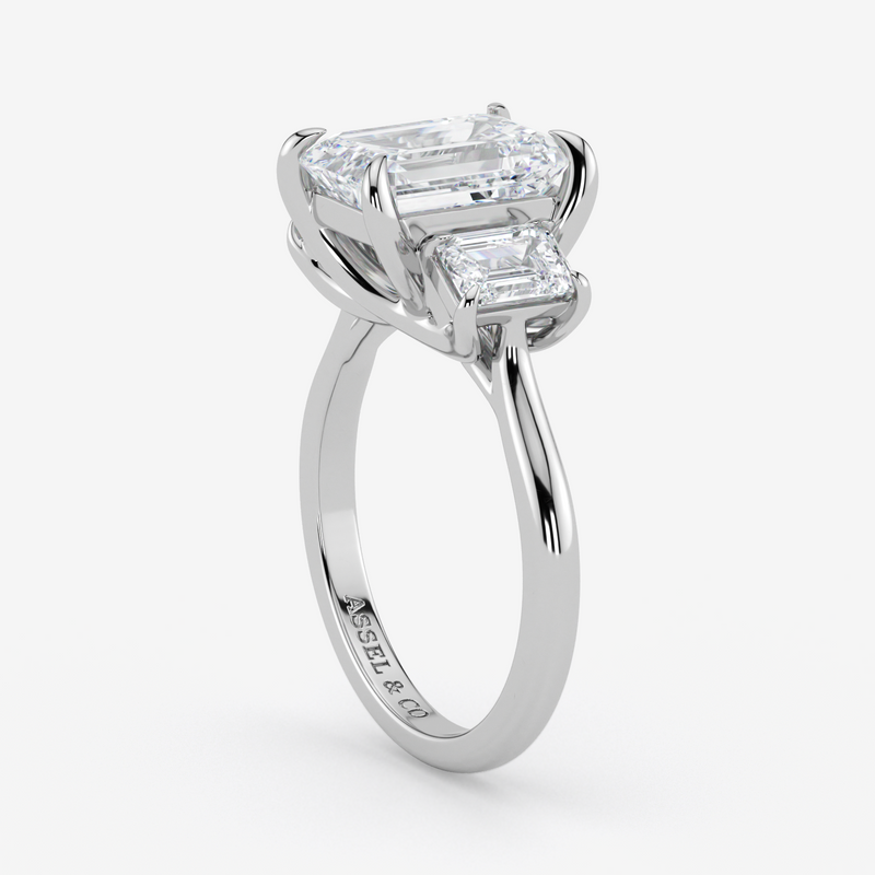 Diamond ring with two rectangular diamonds on a white background