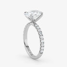 Diamond ring with a white gemstone on a light gray background