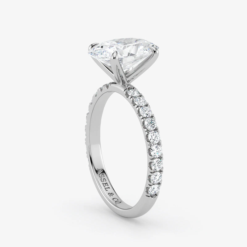 Diamond ring with a white gemstone on a light gray background