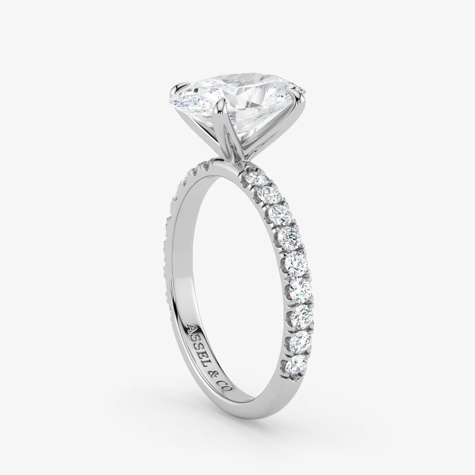 Diamond ring with a white gemstone on a light gray background