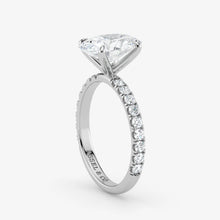 Diamond ring with a white gemstone on a light gray background