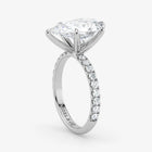Diamond ring with a white gold band on a light gray background