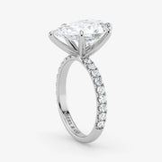 Diamond ring with a white gold band on a light gray background